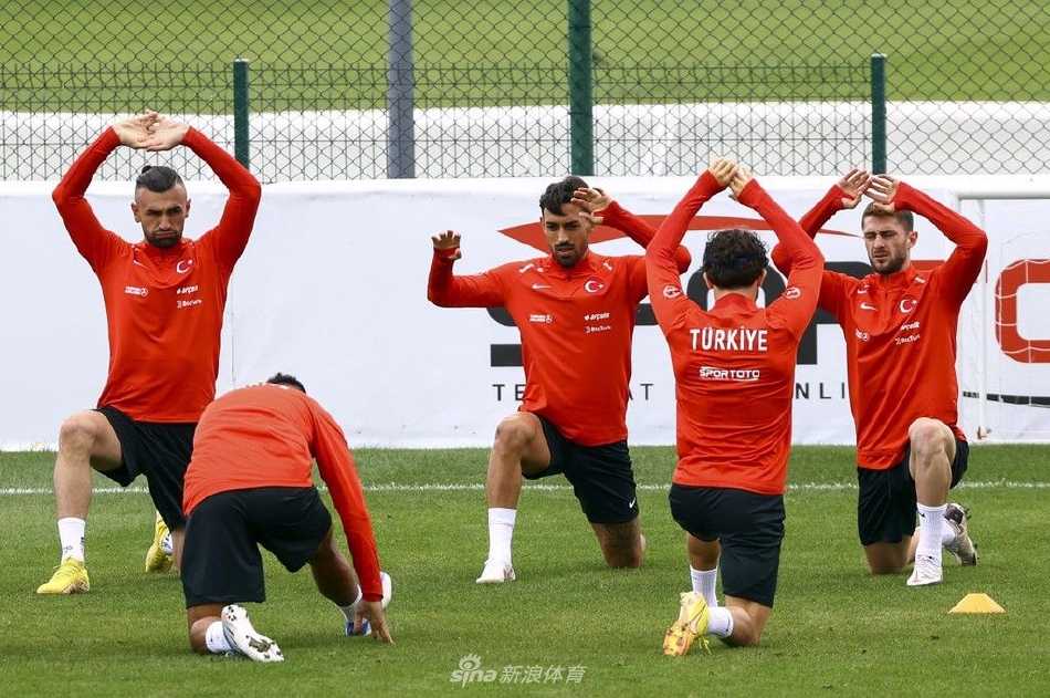 夕阳余晖洒满训练场，球员们进行拉伸与恢复性训练，三三两两的身影构成一幅动静结合的画面，充满竞技之外的沉静与团队温情。