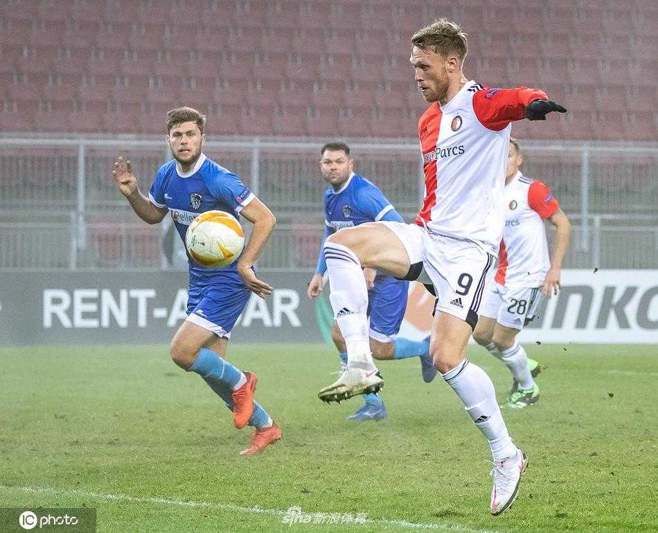 沃尔夫斯贝格球员在主场漫天飞雪中忘情滑跪，背后是闪烁着璀璨灯光的看台与深邃的冬夜