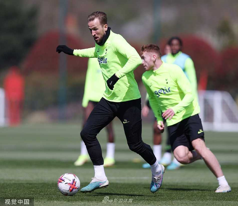 夕阳下球员们结伴离开训练场，长长的身影映在绿茵上，充满斗志