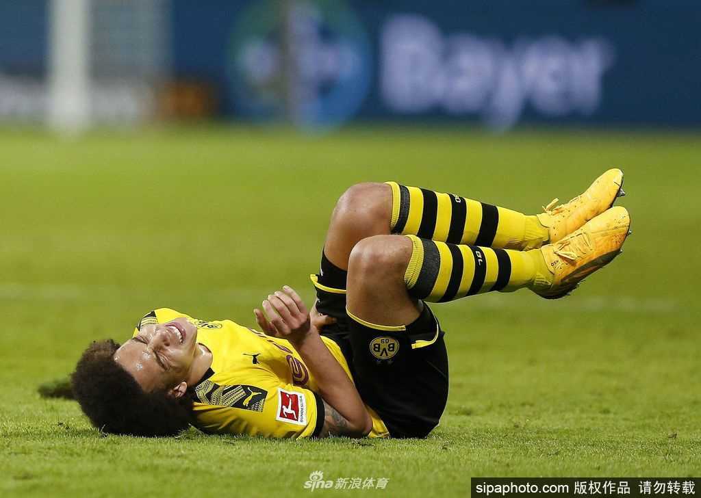 球场外，一个身穿全套主队球衣的小球迷，隔着紧闭的围栏向里面张望，他小小的身影与身后巨大的封闭球场形成了鲜明对比。