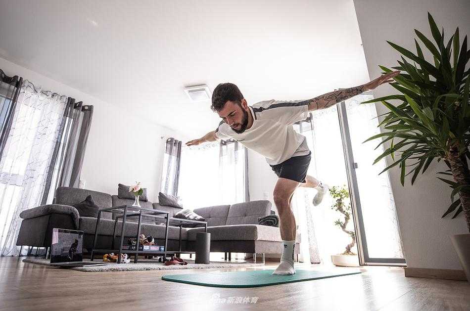 身着休闲装的里希特正在专注地进行自行车训练，汗水浸湿了衣领，背景虽在家中，但那股冲刺的劲头仿佛他正在赛道上进行最后的决战。