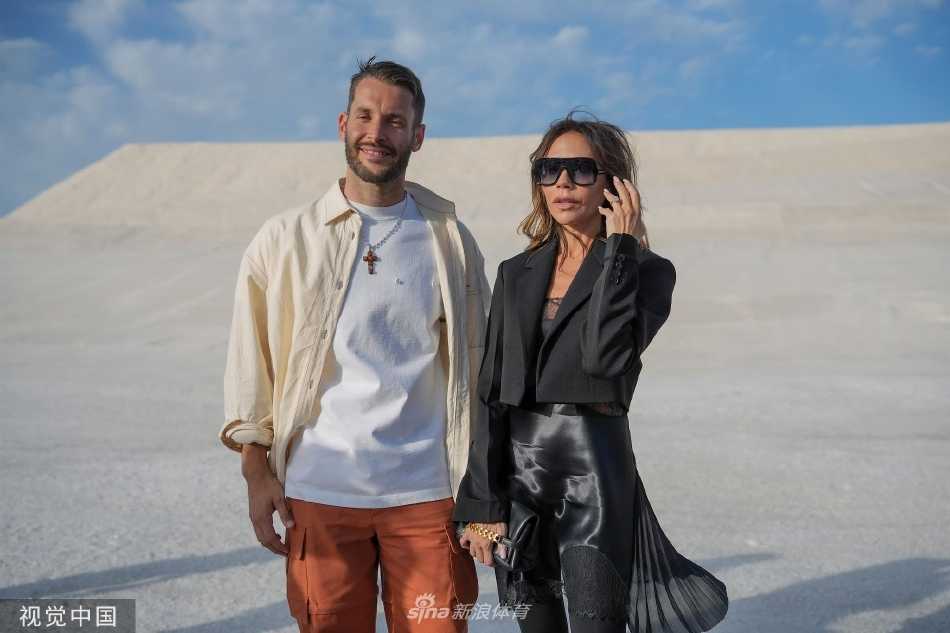 贝克汉姆夫妇并肩而坐，维多利亚专注看秀，大卫绅士陪伴，两人共同构成秀场边一道经典的时尚风景线。