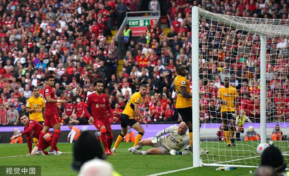 主帅克洛普站在场边，双手插兜凝望球场，其坚定的背影与喧嚣的环境形成对比，沉思着这个戏剧性的赛季结局。