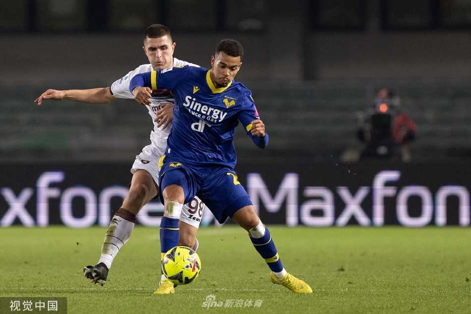 维罗纳后卫多伊格与萨勒尼塔纳前锋迪亚在边线附近激烈拼抢，两人身体对抗互不相让，足球在脚下若隐若现。